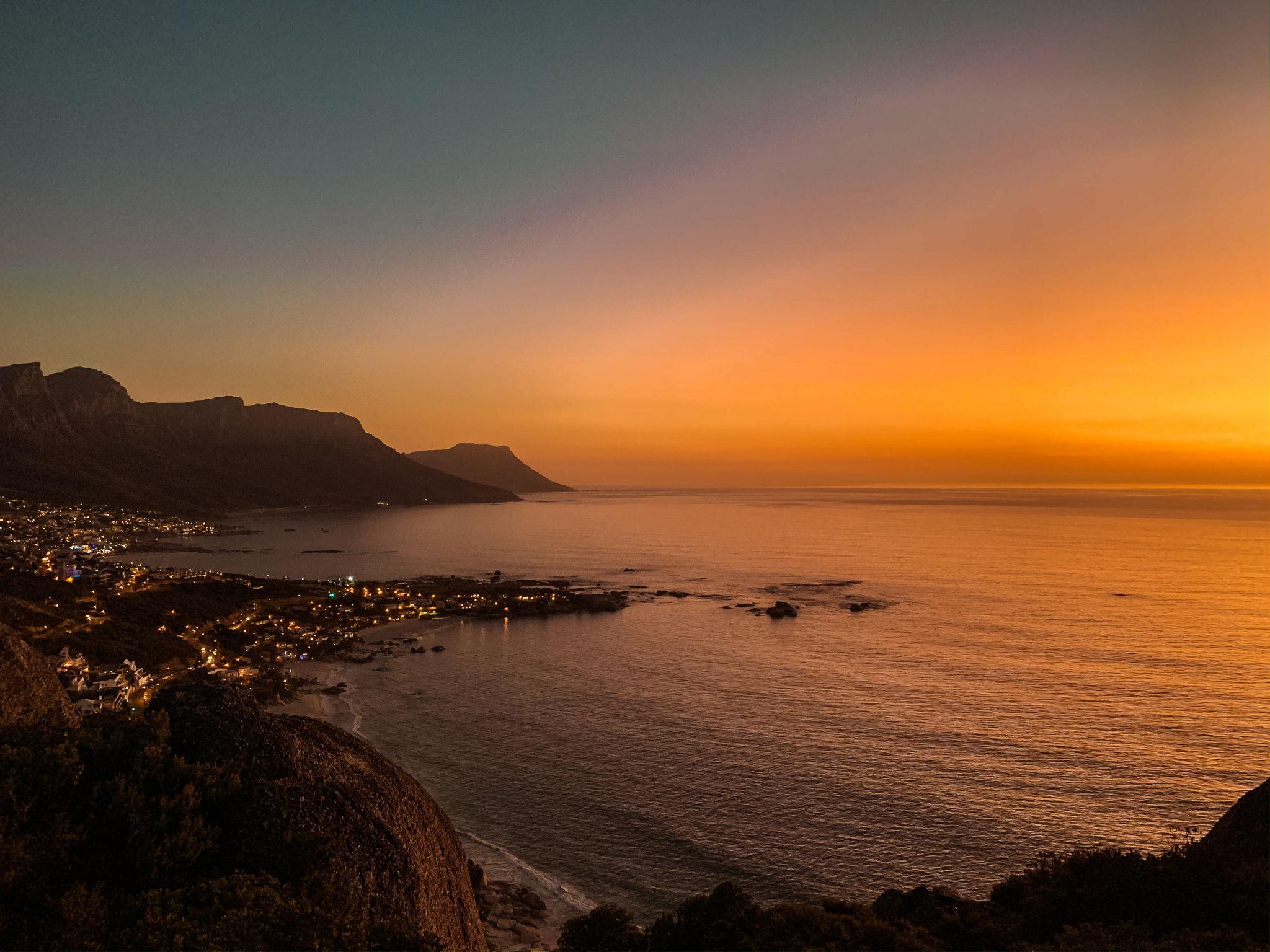 Cape Town coastal landscape at sunset with the ocean and mountains in view