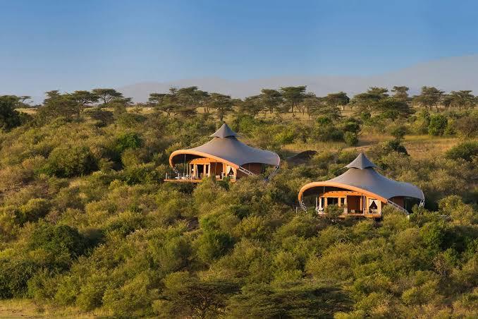 African safari camp in open bush landscape